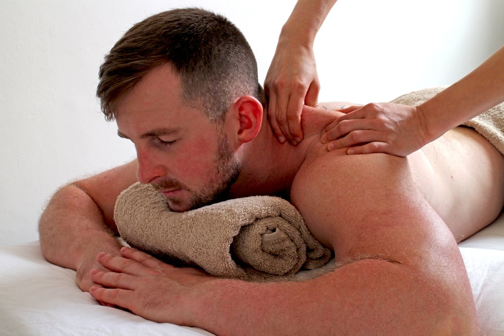 Man relaxing with deep tissue Thai back massage